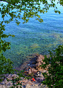 Boys playing on shore rocks Photograph by Bonnie Follett