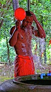 Buddhist monk takes shower Photograph by Robert Bociaga