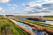 Channel with freighter with wood Photograph by Dutchphotography