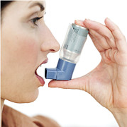 Close-up Of A Young Woman Using An Inhaler Photograph by George Doyle