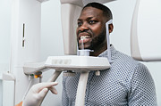 Dentist performing a dental x-ray on a patient Photograph by KoldoyChris