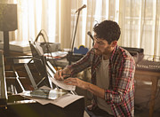Man writing music on piano and a tablet computer Photograph by 10'000 Hours
