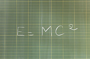 Mass-energy equivalence formula (E = mc2) written on blackboard Photograph by PhotoAlto/Jerome Gorin