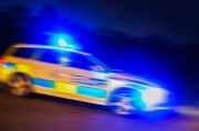 Police car speeding Photograph by Jan Hakan Dahlstrom