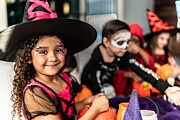 Portrait of a child girl with friends using Halloween costume at home Photograph by FG Trade Latin