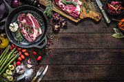 Roasting beef steaks and vegetables on an iron grill with copy space on the table Photograph by Carlosgaw