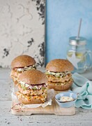 Salmon burgers with cabbage and avocado Photograph by Schall, Ewgenija
