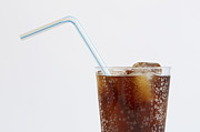 Studio shot of cold drink with ice cubes and plastic straw on white background Photograph by Winslow Productions