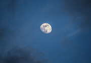 The Moon Seen Through a Break in the Clouds Photograph by John Morzen