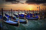 Venice, gondolas or gondole on sunset and church on background. Photograph by Stuart Chard
