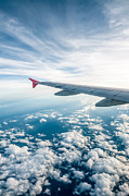 View of the cloudy sky and left airplane wing from a window Photograph by Tbradford