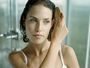 Young woman combing hair, close-up Photograph by Jerome Tisne