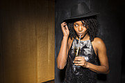 Young woman sipping champagne from a straw Photograph by The Good Brigade