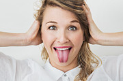 Young woman smiling with her tongue out Photograph by Dimitri Otis