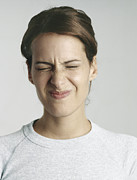 Young woman squinting eyes shut, close-up Photograph by Michele Constantini
