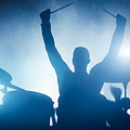 Drummer playing on drums on music concert. Club lights by Michal Bednarek Drummer playing on drums on music concert. Club lights by Michal Bednarek