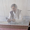 A weaver weaves a carpet. Photograph by Elena Perelman A weaver weaves a carpet. Photograph by Elena Perelman