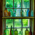 Glass Bottles in a Window by M G Whittingham