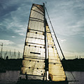 Sailboat in Front of Sun in Harbor Photograph by Andreas Berthold Sailboat in Front of Sun in Harbor Photograph by Andreas Berthold
