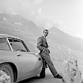 James Bond Coolly Leaning on His Aston Martin Photograph by Doc Braham James Bond Coolly Leaning on His Aston Martin Photograph by Doc Braham