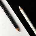Two drawing pencils on a black and white surface. Photograph by Michalakis Ppalis Two drawing pencils on a black and white surface. Photograph by Michalakis Ppalis