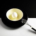 White egg on a yellow bowl. Photograph by Michalakis Ppalis White egg on a yellow bowl. Photograph by Michalakis Ppalis