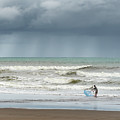 A fisherman with a fishing net on the beach at Gunung Kidul by Anges Van der Logt