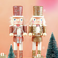 Christmas nutcracker ornaments and gifts against a modern coral background. by Milleflore Images