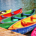 Colorful canoes by the dock by Tatiana Travelways