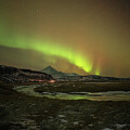 Green and Red aurora dancing over Rivers and mountian peaks unde by Joanne Eastope