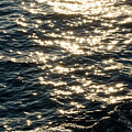 Lens star formed on water body on a sea, A calm ocean reflects sun stars in the morning light. by Arpan Bhatia
