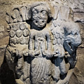 Praying Figure on an Urn by Mary Capriole