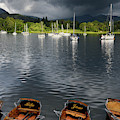 Sailboats moored on Lake Windermere with rowboats on shore at Wa by Reimar Gaertner