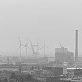 Smog hovering over the city of Amsterdam in black and white by Vaclav Sonnek