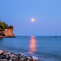 Sturgeon Full Moon Rising Over a Rocky Beach by Alexios Ntounas
