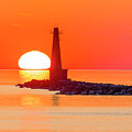 Sunset at the Muskegon South Breakwater Light by Michael Collins