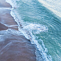 Swirls in the surf left by the waves by Oceanic SkyView